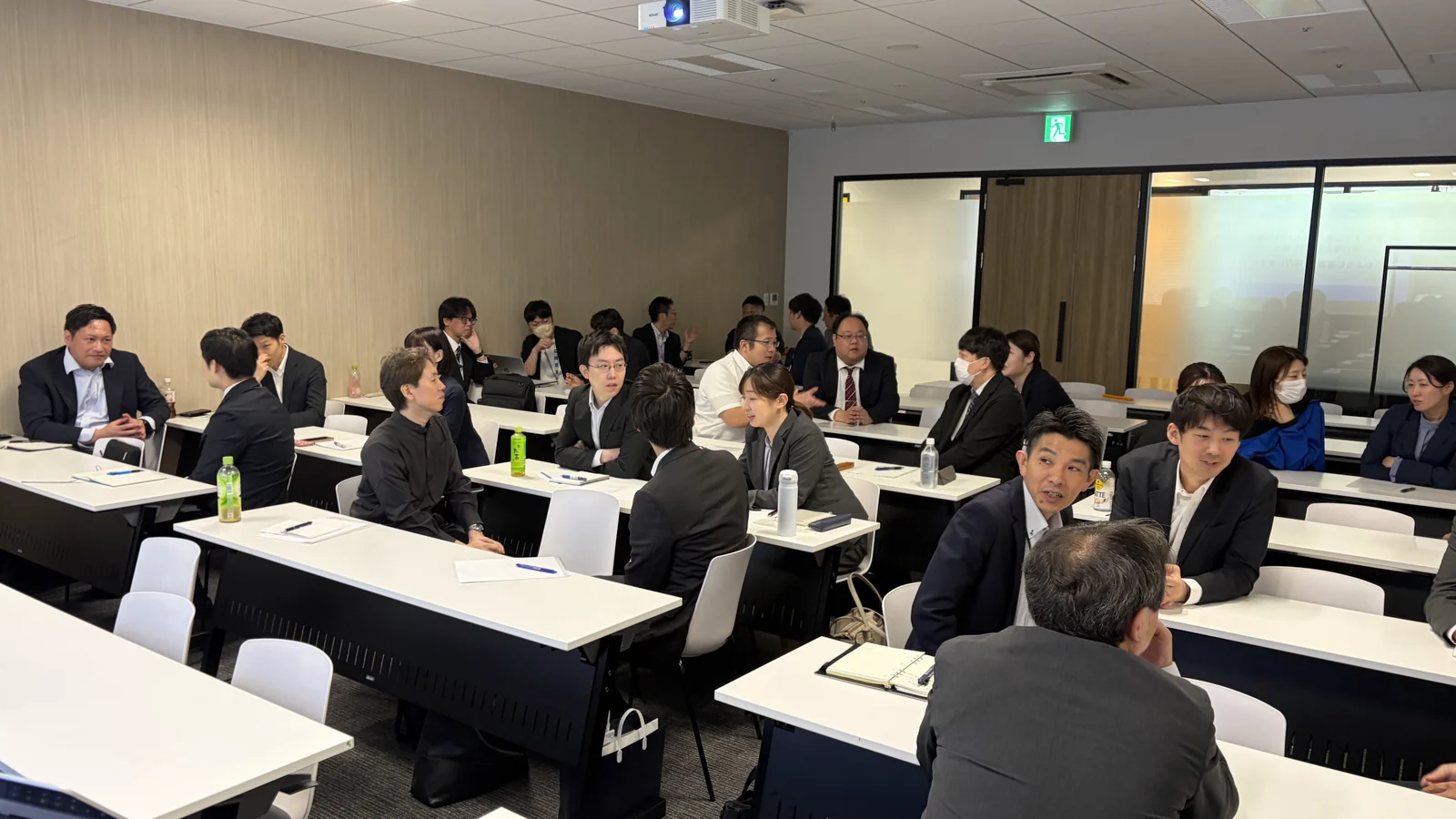 机を囲み、参加者と講師が意見を交わすワークショップ